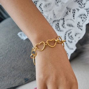 Elegant gold hollow heart link bracelet with OT clasp on wrist for daily fashion