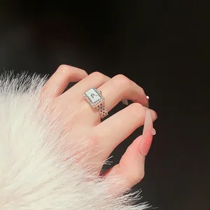 Silver watch-shaped ring with zircon square bezel and iridescent mother of pearl dial