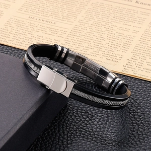 Detailed macro view of black silicone and stainless steel bracelet on a texture box