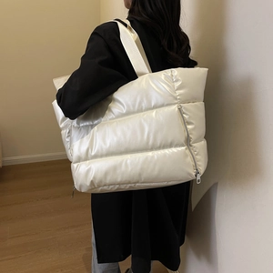 Quilted waterproof fitness tote bag in pearl white shown as a side view on a model