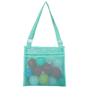 Detail of mint green mesh beach bag with adjustable strap and colorful play balls