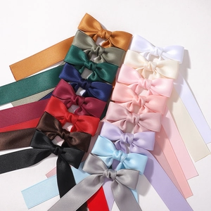 Detailed collection of satin bow hair clips in various colors with long hanging ribbons