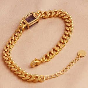 Close-up of gold chain bracelet featuring a rectangular purple zircon gemstone and silk backdrop