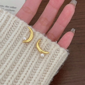 Elegant 925 sterling silver moon pearl stud earrings in gold finish worn on ear