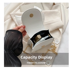 Detailed view of the white PU leather mini crossbody bag with chic bow and golden chain.
