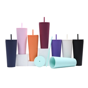 Set of eight multi-colored matte double-wall plastic tumblers with straws on white stands