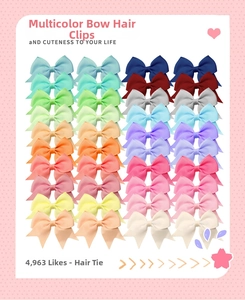 Flat lay of 40 multi-color grosgrain ribbon bow clips on polka dot display cards