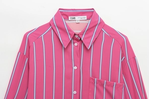 Close-up of pleated striped shirt collar and pocket in rose pink and blue tones