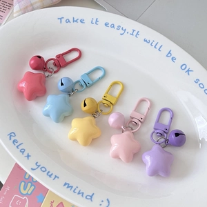 Star bell keychains in pastel macaron colors featuring matte finish and metal snap hooks