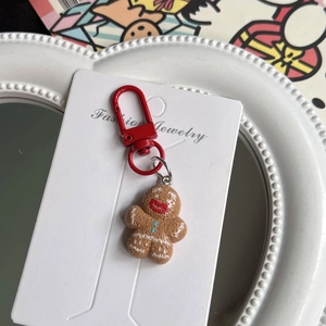Macro view of cute gingerbread man keychain with red clasp and sugar glaze details