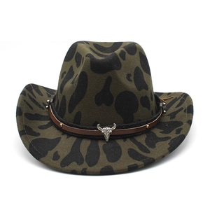 Detail of olive green wool felt hat featuring black cow print and silver bull head emblem