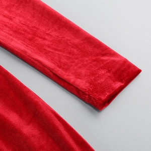 Close-up detail of luxurious red velvet fabric texture on an elegant off-shoulder dress