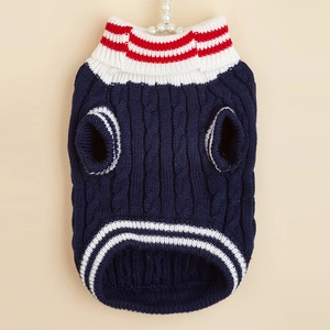 Close-up of dark blue knit dog sweater with red and white striped turtleneck detail