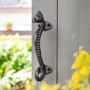 Nordic minimalist black cast iron seahorse drawer handle mounted on gray wood post