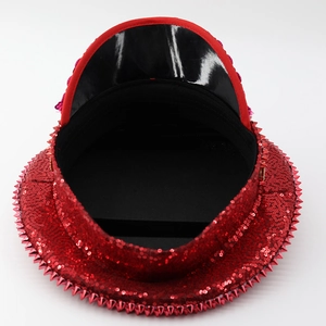 Top view of red sequin captain hat with spiked stud trim for stage performances