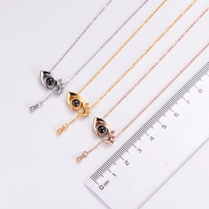 Three-color Evil Eye necklaces shown with a ruler for 2cm pendant size detail