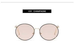 Detail view of round champagne lenses with gold metal frames and stylish black rims