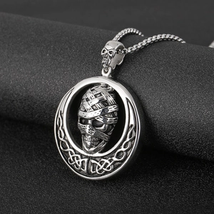 Close-up of gothic mummy skull pendant with Celtic knot details on box chain