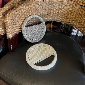 Detail of silver rhinestone and cream pearl beaded handmade round evening handbags