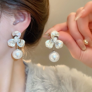 Close-up of pearl flower earrings with gold plating and elegant petal design details