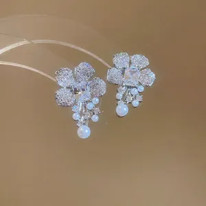Silver flower drop earrings with zircon crystals and elegant white pearl tassels