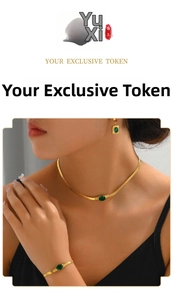 Golden snake chain set with oval emerald pendant including necklace and bracelet on model