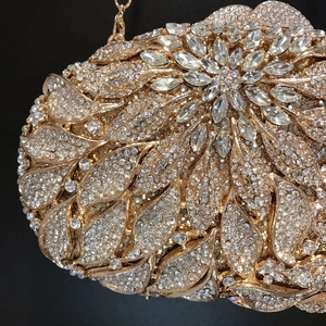 Macro shot of gold evening clutch featuring detailed crystal floral patterns and rhinestones
