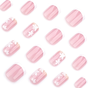 French white tip press-on nails with white floral patterns and soft pink base