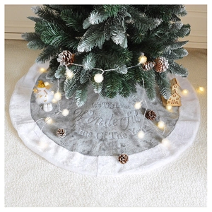 Detailed embroidery of Christmas quote on plush grey and white tree skirt ornament