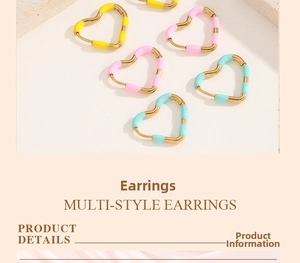 Detail of colorful enamel heart earrings in pink yellow and mint green on stone base