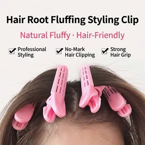 Pinces à cheveux roses pour volume aux racines et coiffage de frange sur modèle