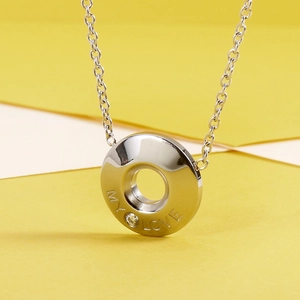 Macro detail of silver titanium steel necklace pendant with MY LOVE engraving and zircon