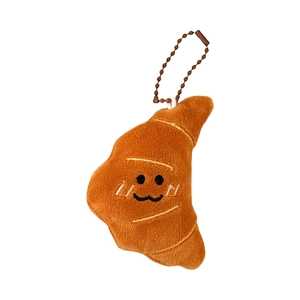 Cute plush croissant keychain pendant with metal chain displayed on a white background