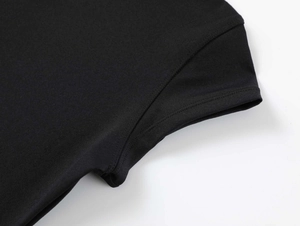 Macro shot of precise flat-seam stitching on black stretch athletic fabric T-shirt