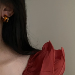 Detail of amber resin hoop earring on model showing warm caramel tones and vintage style