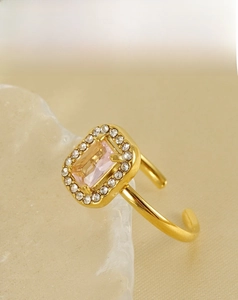 Macro shot of 18K gold plated ring with rectangular pink stone and zircon detail