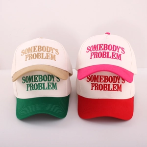 Detailed embroidery of SOMEBODY'S PROBLEM text on adjustable cotton baseball caps