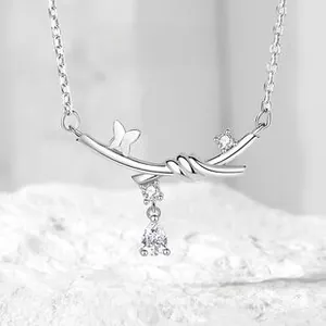 Detail of S925 silver necklace with thorn bow design and teardrop zircon pendant