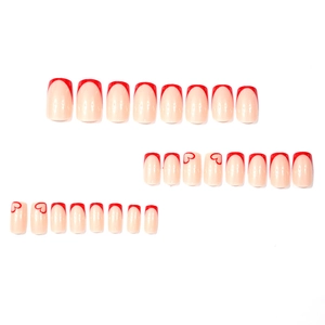 Classic red French tip press-on nails with heart patterns on natural nude base