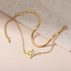 Gold double-layer stainless steel bracelet featuring snake chain and Celtic knot charm