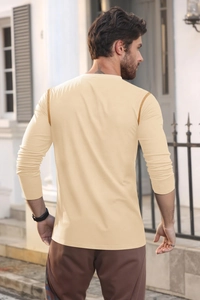Detail of men's long-sleeve beige polo shirt featuring contrast shoulder stitching
