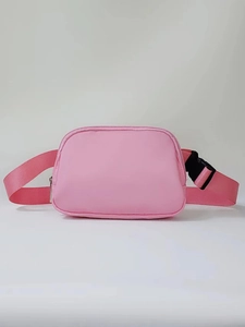 Detail view of pink waterproof sports waist bag with adjustable strap and buckle closure