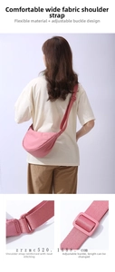 Detail of adjustable wide fabric strap and stitching on pink nylon crossbody bag