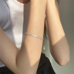 Minimalist 925 sterling silver mesh bracelet worn on wrist with elegant metallic shimmer