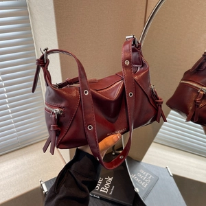 Modern burgundy PU leather tote bag with silver zippers and eyelet straps in mirror reflection