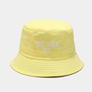 Detailed embroidery of NEW YORK lettering on the yellow cotton fisherman bucket hat