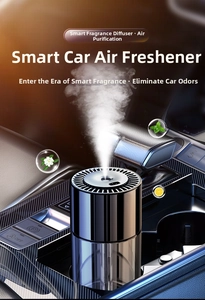 Macro shot of a black smart car diffuser misting aromatic spray in a luxury vehicle interior