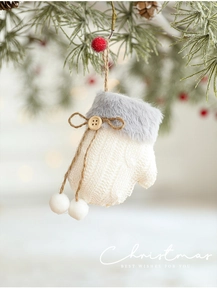 Close-up of white cable knit Christmas glove ornament with grey faux fur and wooden button