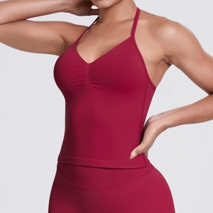 Detailed close-up of dark red seamless yoga set featuring a halter V-neck top and leggings