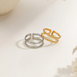 Detail view of gold and silver double-layered bamboo style adjustable stainless steel rings